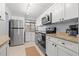 Updated kitchen with granite countertops, stainless steel appliances, and white cabinets at 1986 Pelican Landing Blvd # 1514, Clearwater, FL 33762