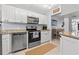 Bright kitchen with white cabinets, stainless steel appliances, granite countertops, and a breakfast nook at 1986 Pelican Landing Blvd # 1514, Clearwater, FL 33762