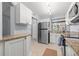Charming kitchen with granite countertops, stainless steel refrigerator, and white cabinets at 1986 Pelican Landing Blvd # 1514, Clearwater, FL 33762