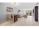 Open living room featuring tile flooring, light blue walls, a dining area, and a sliding glass door to the porch at 1986 Pelican Landing Blvd # 1514, Clearwater, FL 33762