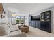 Comfortable living room with a plush sofa, dark cabinets and view to the lanai at 1986 Pelican Landing Blvd # 1514, Clearwater, FL 33762