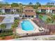 Aerial view of community pool, tennis court, lounge seating, and meticulously landscaped grounds at 1986 Pelican Landing Blvd # 1514, Clearwater, FL 33762