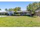 Inviting single-story home featuring a long driveway, garage, and a well-maintained front lawn at 2041 Hillwood Dr, Clearwater, FL 33763