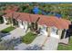 Aerial view of townhomes showcasing the red roofs and surrounding community at 21205 Calle Rosa Dr # 10, Land O Lakes, FL 34637
