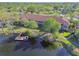 Aerial view of the back of the complex featuring balconies, docks and a serene lake at 21205 Calle Rosa Dr # 10, Land O Lakes, FL 34637