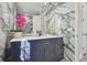 Sleek bathroom with navy blue vanity, marble accent wall, and stylish decor at 21205 Calle Rosa Dr # 10, Land O Lakes, FL 34637