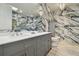 Modern bathroom with double sinks, marble walls, and a sleek vanity at 21205 Calle Rosa Dr # 10, Land O Lakes, FL 34637