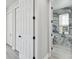 Hallway view into bathroom with marble accent wall and wood-look tile floors at 21205 Calle Rosa Dr # 10, Land O Lakes, FL 34637
