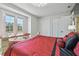 Bright bedroom features a balcony view, closet space, and luxury furnishings at 21205 Calle Rosa Dr # 10, Land O Lakes, FL 34637