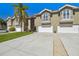 Charming townhome exteriors boast attached garages, small balconies, and lush green lawns in front at 21205 Calle Rosa Dr # 10, Land O Lakes, FL 34637