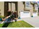 Townhome exterior featuring a garage, balcony and a neatly landscaped yard with colorful potted plants at 21205 Calle Rosa Dr # 10, Land O Lakes, FL 34637