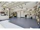 Spacious garage features painted floor, overhead lighting, and storage solutions at 21205 Calle Rosa Dr # 10, Land O Lakes, FL 34637