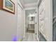 Hallway view to bathroom with marble accent wall and modern vanity at 21205 Calle Rosa Dr # 10, Land O Lakes, FL 34637