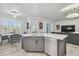 Bright kitchen with an island, stainless steel dishwasher, and dining area at 21205 Calle Rosa Dr # 10, Land O Lakes, FL 34637