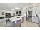 Modern kitchen flows into the living area, featuring stainless steel appliances and bar seating at the island at 21205 Calle Rosa Dr # 10, Land O Lakes, FL 34637