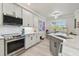 Well-equipped kitchen boasts stainless steel appliances and ample white cabinetry at 21205 Calle Rosa Dr # 10, Land O Lakes, FL 34637