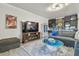 Cozy living room featuring large TV, fireplace, and stylish decor, perfect for relaxation and entertainment at 21205 Calle Rosa Dr # 10, Land O Lakes, FL 34637