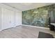 Spacious home office with a decorative accent wall and closet storage at 21205 Calle Rosa Dr # 10, Land O Lakes, FL 34637