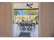 Enclosed patio with dining table and seating area overlooking a peaceful pond at 21205 Calle Rosa Dr # 10, Land O Lakes, FL 34637