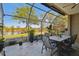 Screened lanai offers picturesque water view with outdoor dining set and retractable awning for comfortable entertaining at 21205 Calle Rosa Dr # 10, Land O Lakes, FL 34637