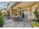 Inviting outdoor patio with ceiling fan, stone flooring and a view of the screened-in lanai at 21205 Calle Rosa Dr # 10, Land O Lakes, FL 34637