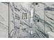 Modern shower showcasing marble tile, niche, rainfall shower head, and glass door at 21205 Calle Rosa Dr # 10, Land O Lakes, FL 34637