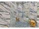 Luxurious shower featuring marble walls, mosaic floor, and glass enclosure at 21205 Calle Rosa Dr # 10, Land O Lakes, FL 34637