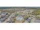 Aerial view of a residential community featuring a swimming pool and tennis courts at 2514 Sandy Hill Ct, Holiday, FL 34691