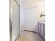 Bathroom with tiled floor, shower stall, double-door closet, and neutral color scheme at 2514 Sandy Hill Ct, Holiday, FL 34691