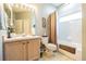 Bathroom with tub-shower combo, large mirror, and a light wood vanity at 2514 Sandy Hill Ct, Holiday, FL 34691