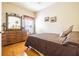 Bedroom with hardwood floors, simple decor, and a cozy atmosphere at 2514 Sandy Hill Ct, Holiday, FL 34691