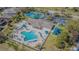 Aerial view of community amenities including a pool, tennis courts, and recreational area at 2514 Sandy Hill Ct, Holiday, FL 34691