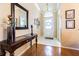 Elegant foyer with hardwood floors, white tile, and stylish furnishings at 2514 Sandy Hill Ct, Holiday, FL 34691