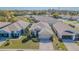 Aerial view of a well-maintained home with a manicured front lawn and two-car garage at 2514 Sandy Hill Ct, Holiday, FL 34691