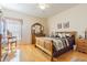 Bedroom featuring wood floors, a ceiling fan, and neutral walls with a decorative vanity area at 2514 Sandy Hill Ct, Holiday, FL 34691