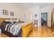 Bedroom with hardwood floors and a view into the ensuite bathroom and living areas at 2514 Sandy Hill Ct, Holiday, FL 34691