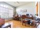 Spacious office area featuring hardwood floors, large windows, and desk area at 2514 Sandy Hill Ct, Holiday, FL 34691