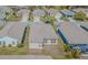 Aerial view of a home's backyard with manicured lawn and screened-in patio at 2514 Sandy Hill Ct, Holiday, FL 34691