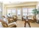Bright sunroom filled with natural light, wicker furniture, and views of the outdoors at 2514 Sandy Hill Ct, Holiday, FL 34691