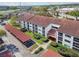 Aerial view of the condo complex with well-maintained grounds and covered parking at 2595 Countryside Blvd # 8-305, Clearwater, FL 33761