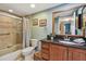 Well-lit bathroom with shower, vanity, and granite countertops at 2595 Countryside Blvd # 8-305, Clearwater, FL 33761