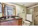 Bathroom with granite countertop, wood cabinets, mirror, and glass shower with tile surround at 2595 Countryside Blvd # 8-305, Clearwater, FL 33761