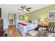 Bedroom featuring bed and ceiling fan, looking to open bathroom at 2595 Countryside Blvd # 8-305, Clearwater, FL 33761