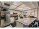 Well-equipped kitchen featuring stainless steel appliances, granite counters, and a breakfast bar at 2595 Countryside Blvd # 8-305, Clearwater, FL 33761