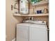 Laundry room featuring washer and dryer with shelving and water heater at 2595 Countryside Blvd # 8-305, Clearwater, FL 33761