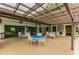 Outdoor patio with tables, chairs, and shaded pergola, perfect for dining and relaxing at 2595 Countryside Blvd # 8-305, Clearwater, FL 33761