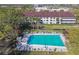 Aerial view of a community pool with lounge chairs and manicured landscaping at 2595 Countryside Blvd # 8-305, Clearwater, FL 33761