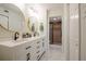 Modern bathroom with dual sinks, stylish gold mirrors, and a sleek shower at 3211 W Swann Ave # 602, Tampa, FL 33609