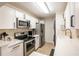 Modern kitchen featuring stainless steel appliances, bright countertops, and white cabinetry at 3211 W Swann Ave # 602, Tampa, FL 33609