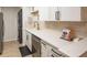 Close-up of the kitchen area showcasing quartz countertops, modern appliances, and a convenient washer/dryer at 3211 W Swann Ave # 602, Tampa, FL 33609